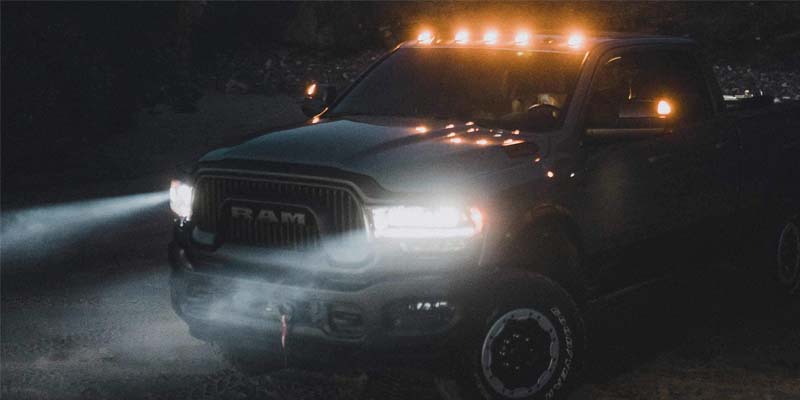 Image of the 2024 RAM 2500 at night, showcasing the bright LED headlights and cab roof lights