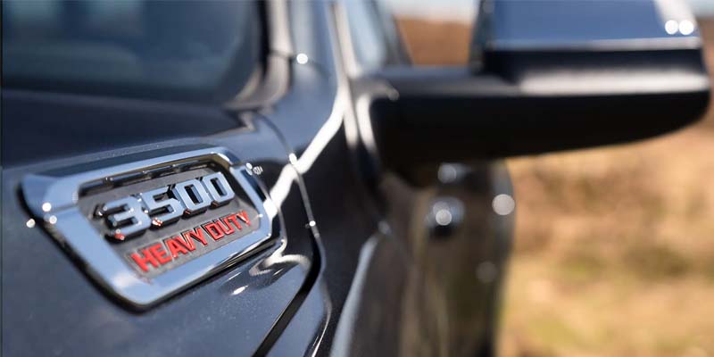 Close-up image of the 2024 RAM 3500 Heavy-Duty emblem on the driver's side of the hood
